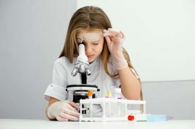 girl looking in microscope
